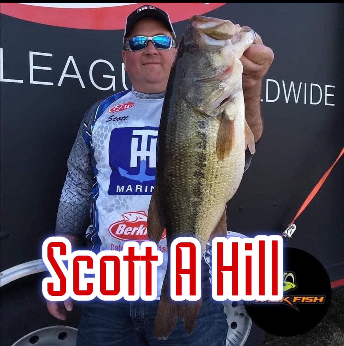 Angler holding a large fish in front of a tournament backdrop, with “Scott A Hill” text overlay.