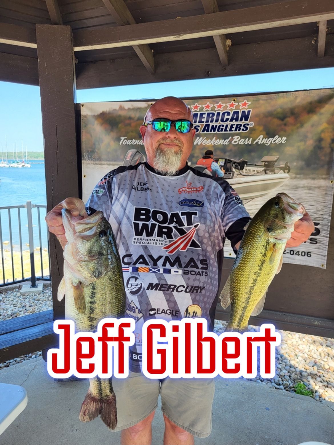 Man holding two fish under a pavilion, with a fishing sign and “Jeff Gilbert” text overlay.
