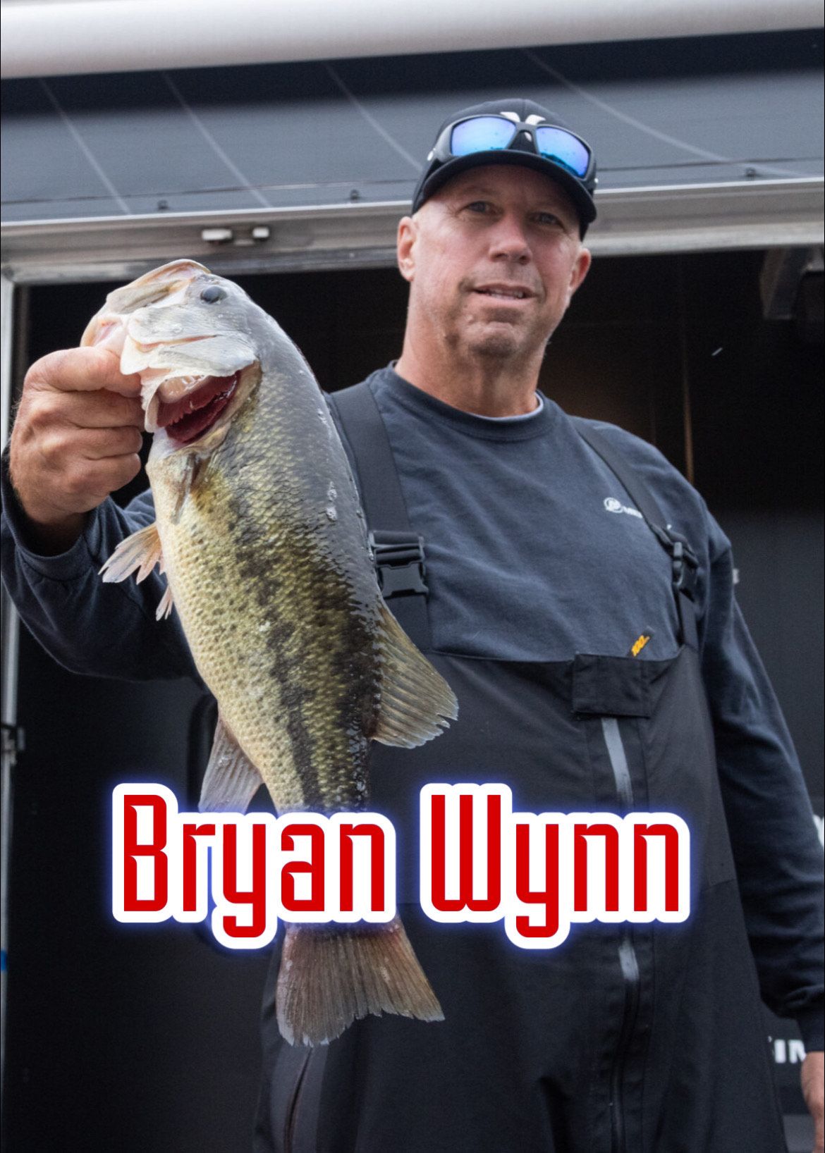 Man holding a large fish on a dock, with the name “Bryan Wynn” overlaid in red text.
