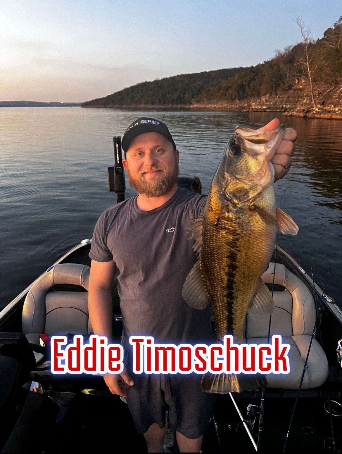 Man holding a large fish on a boat at sunset, with “Eddie Timoschuk” text overlay