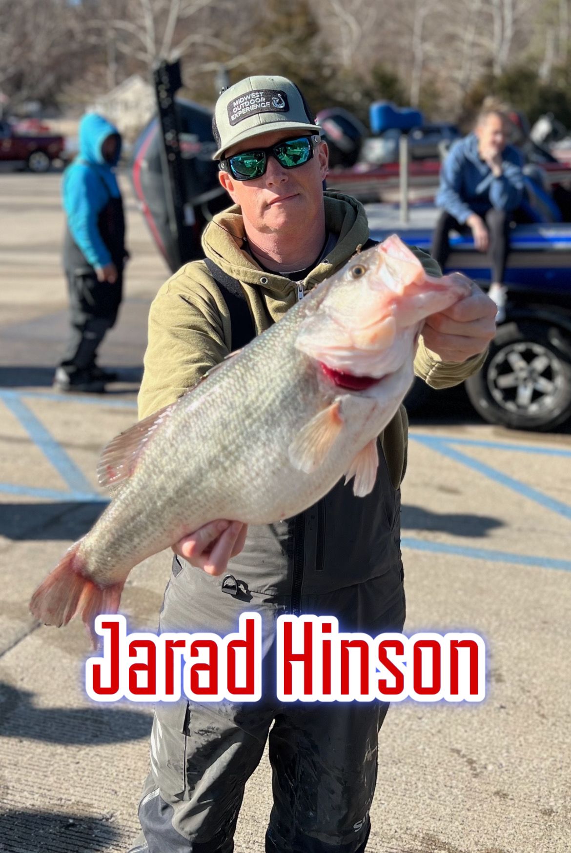 Man holding a large fish in a parking lot, with the name “Jarad Hinson” overlaid.