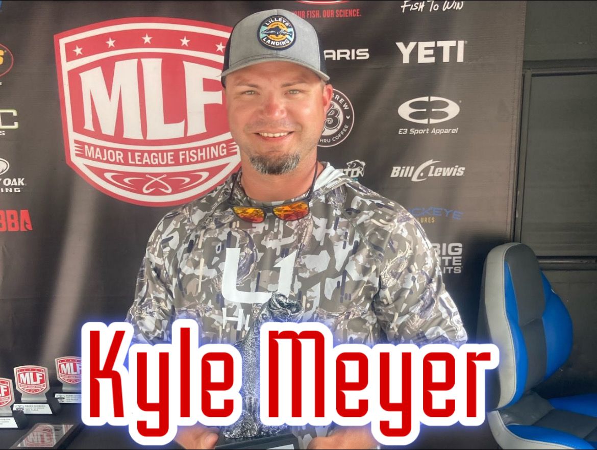 Kyle Meyer smiling in camo gear at an MLF fishing event backdrop