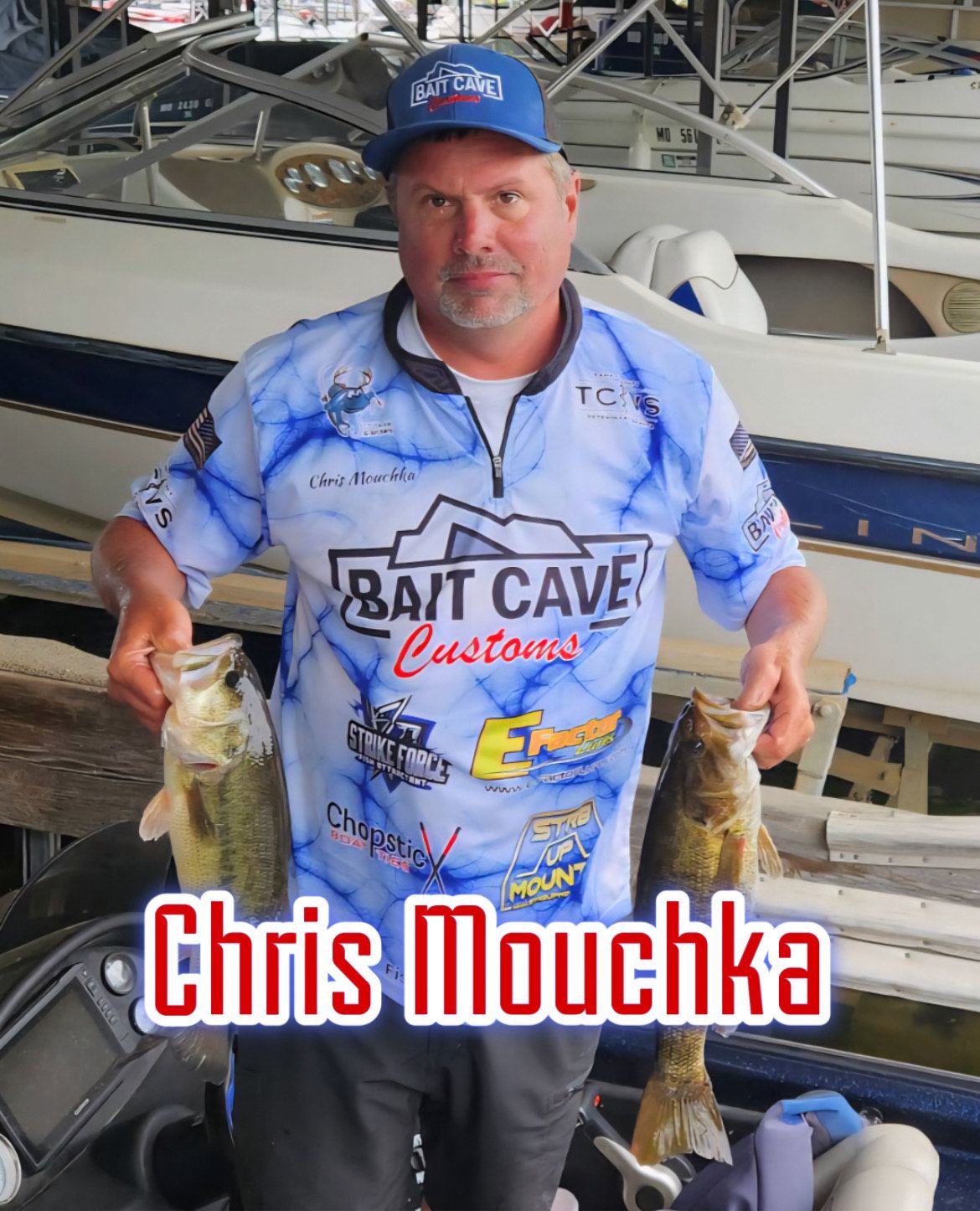 Man in blue fishing shirt and cap holding two fish beside a boat, with “Chris Mouchka” text.