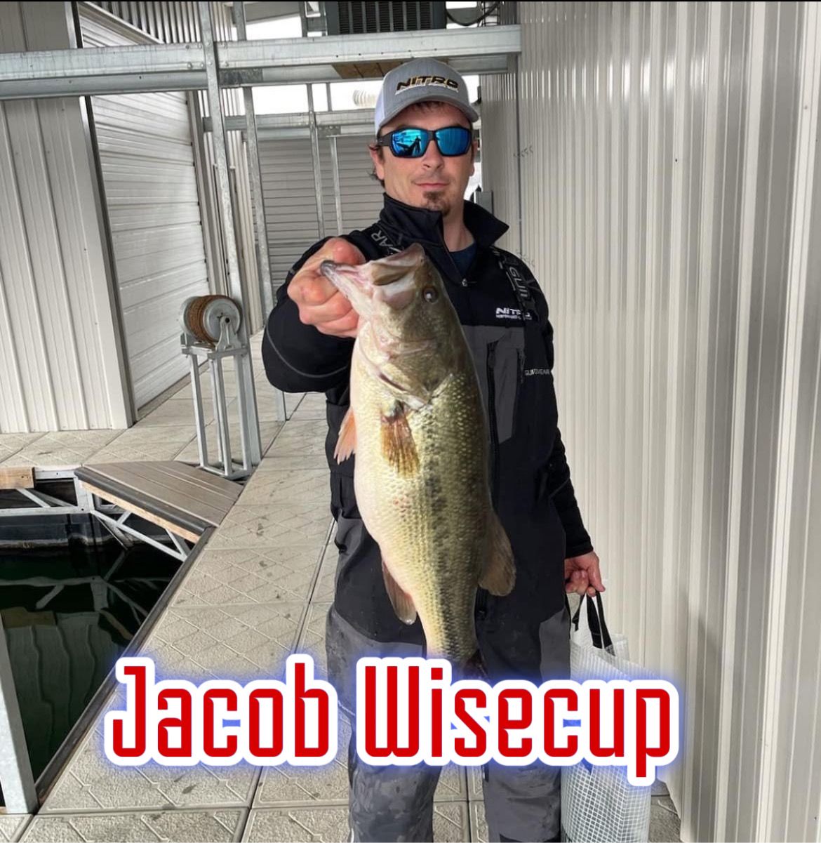 Angler holding a large bass on a dock, with the name “Jacob Wisecup” overlaid at the bottom.