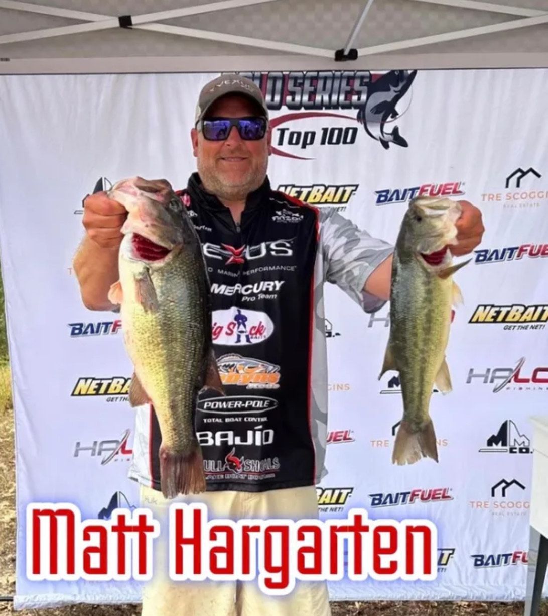 Angler holding two largemouth bass in front of sponsor backdrop, with “Matt Hargaten” text.