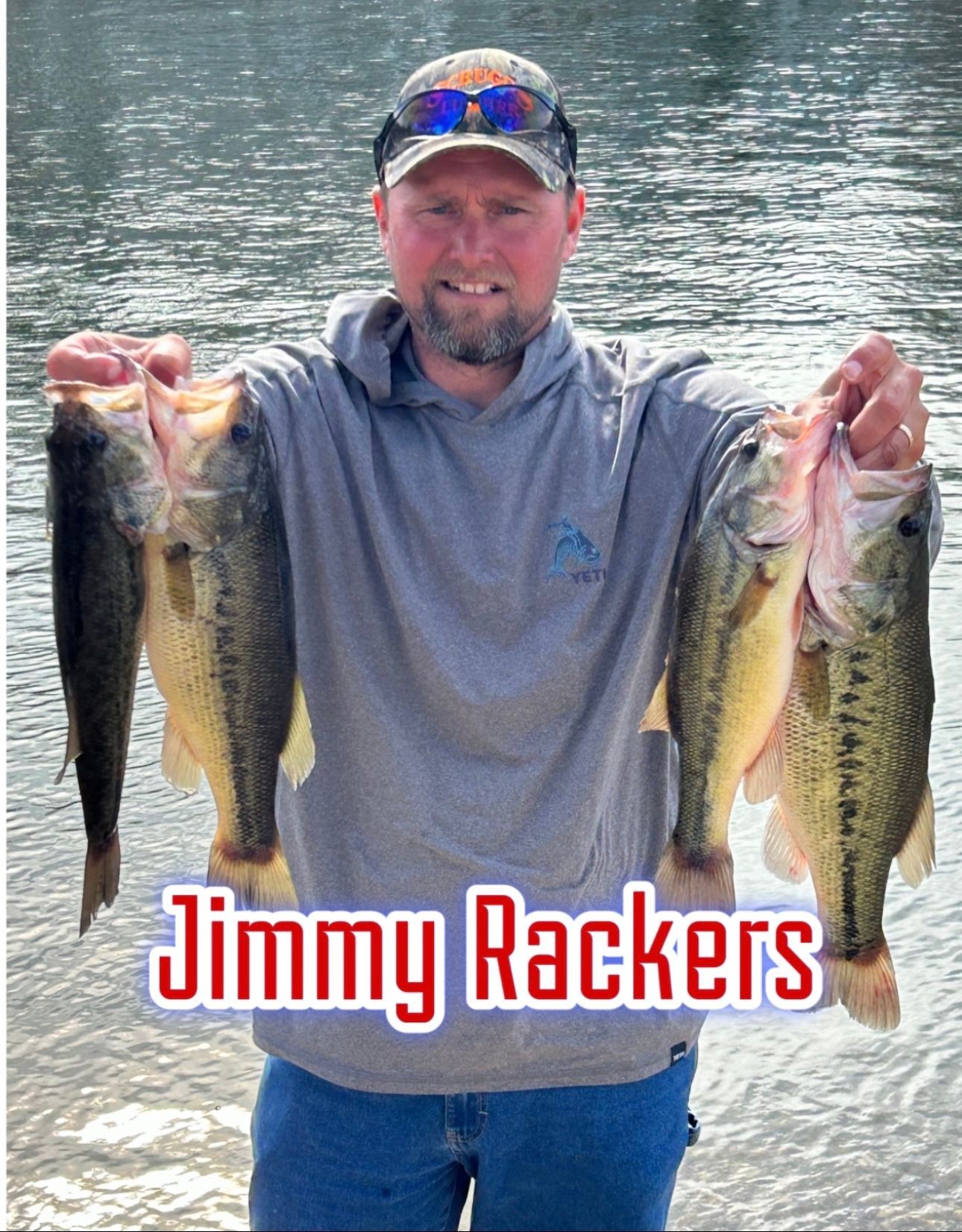 Man holding three fish by a lake, wearing a cap and gray shirt, with “Jimmy Rackers” text overlay.