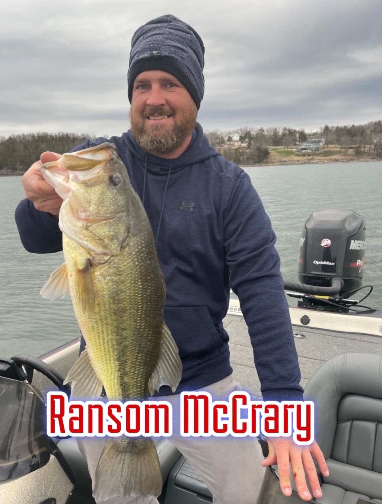 Man holding a large bass on a boat, with the name “Ransom McCrary” overlaid at the bottom.