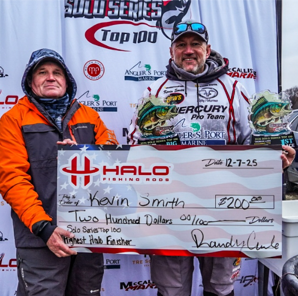 Two people holding an oversized $200 check at a fishing awards event backdrop