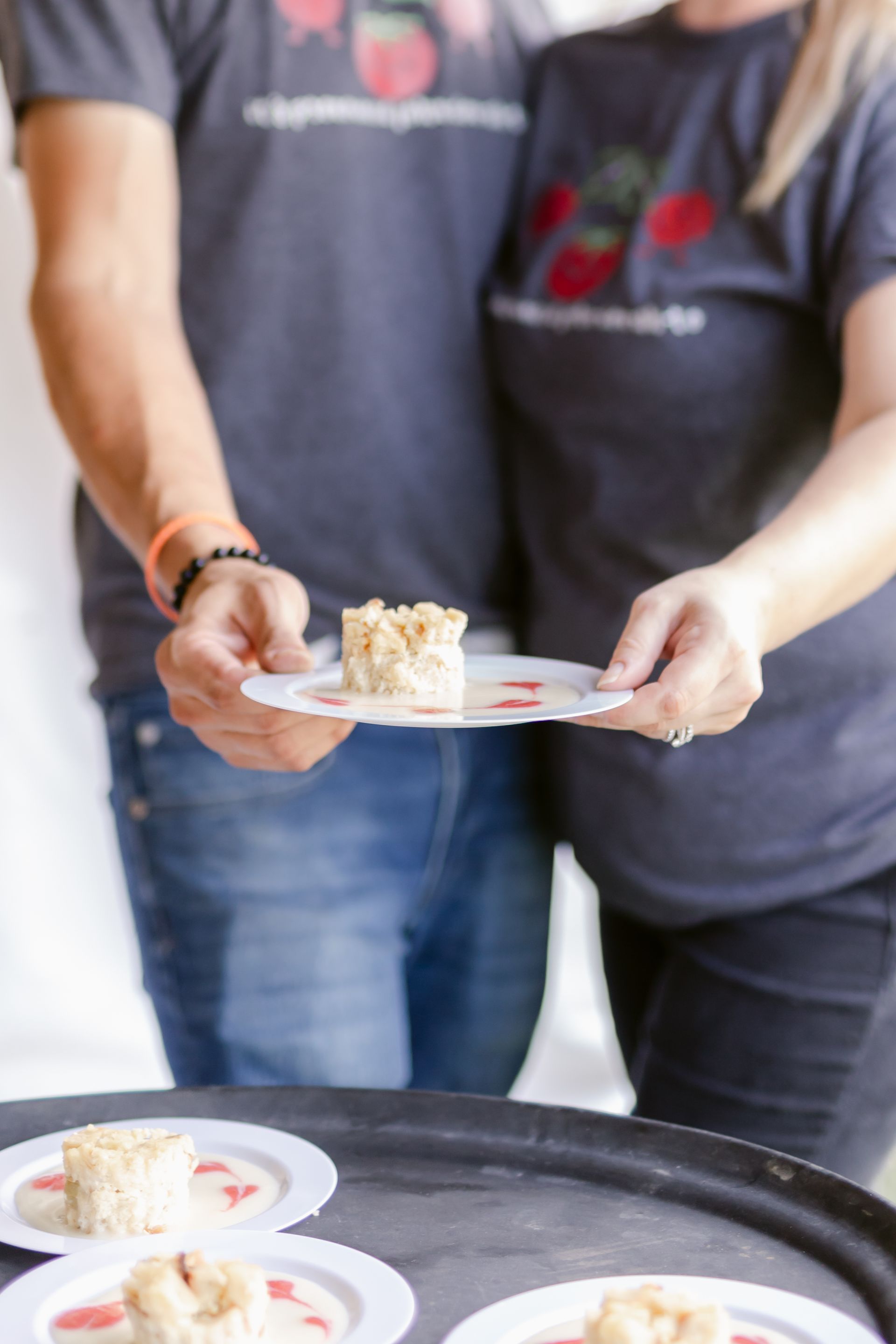 A man and a woman are holding plates of food.
