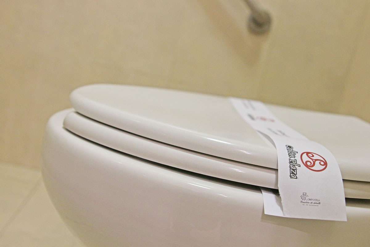 Asiento de inodoro blanco cerrado con una etiqueta de 
