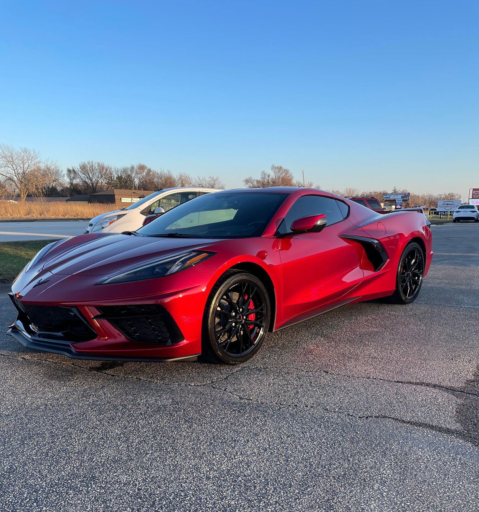 Red Chevrolet Corvette sports car parked outdoors.