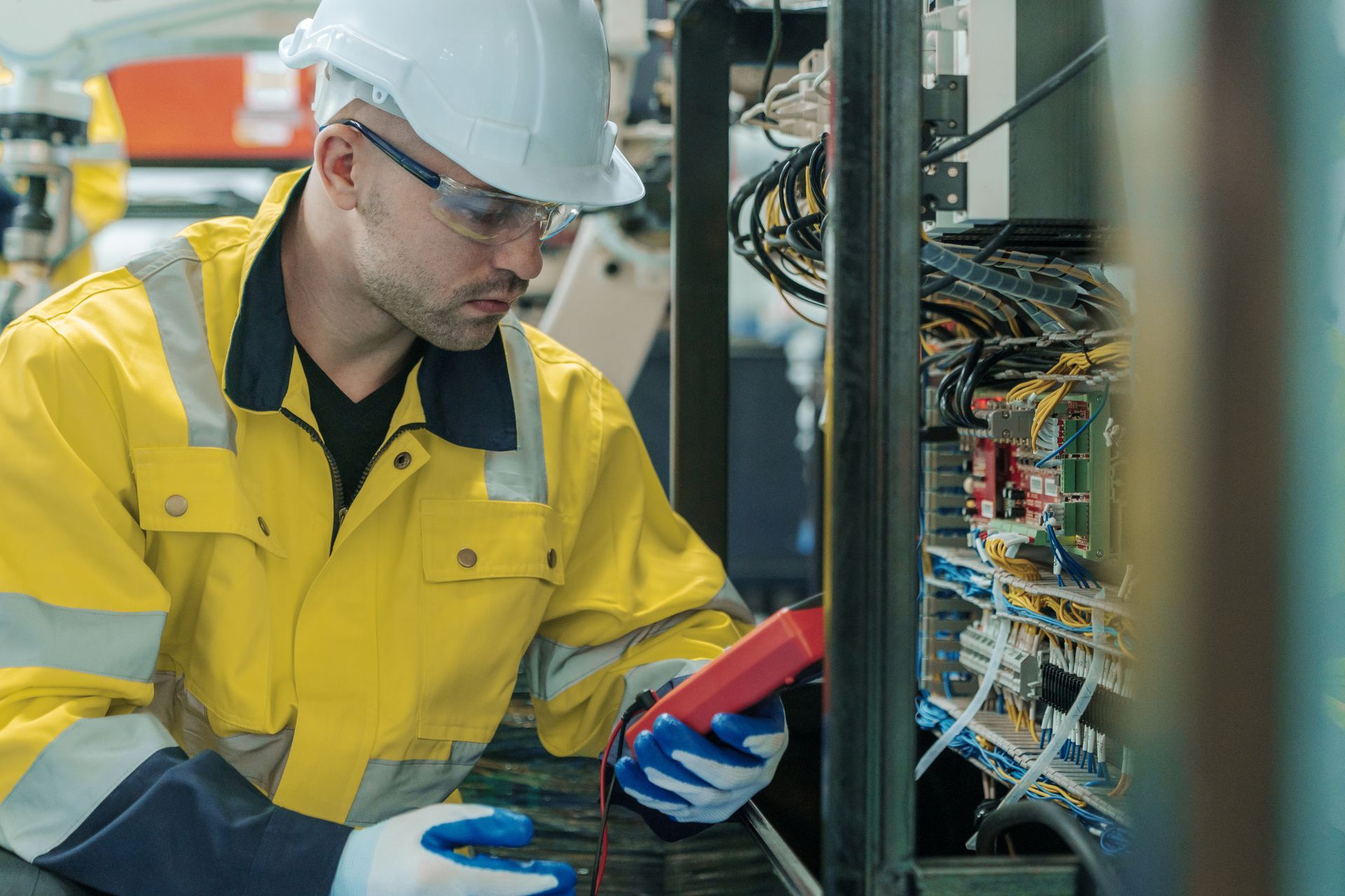 An electrician is measuring the voltage of a power electric line.