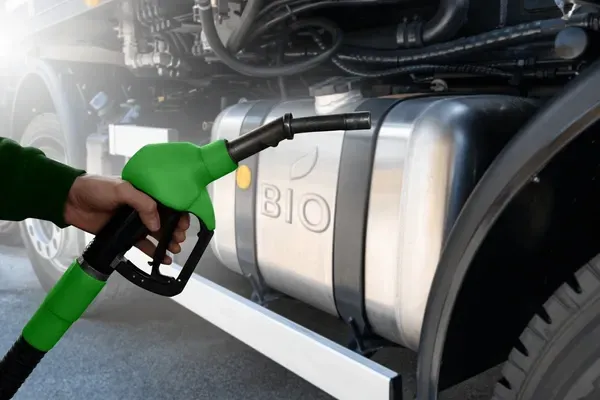 Hand fueling truck with green pump labeled 