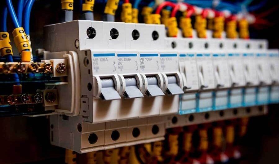 A close up of a row of electrical switches and wires.