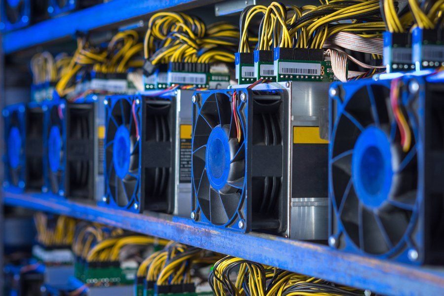 A row of fans sitting on top of a shelf in a data center.