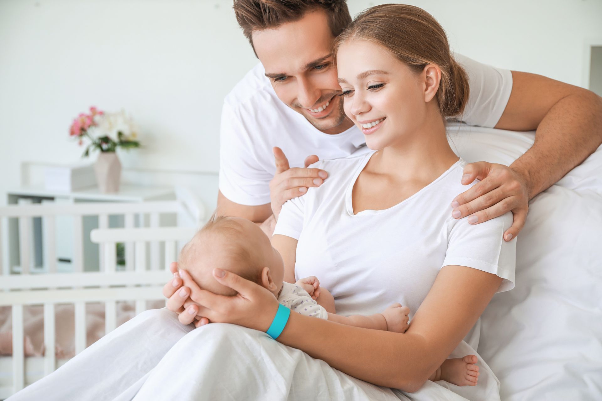 Young family with newborn baby in maternity hospital.