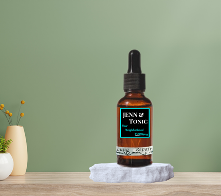 A bottle of jenn & tonic Lung Repair tincture is sitting on a wooden table.