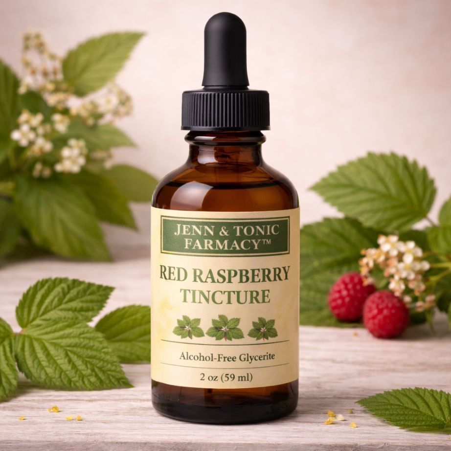 A 2 oz bottle of "Jenn & Tonic Farmacy" Red Raspberry Tincture, centered between raspberry leaves and fruit.