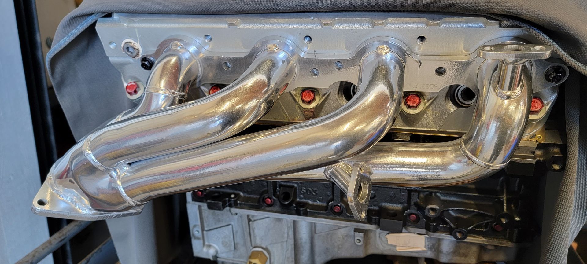 A close up of a exhaust pipe on a car engine | Griffin Motorwerke