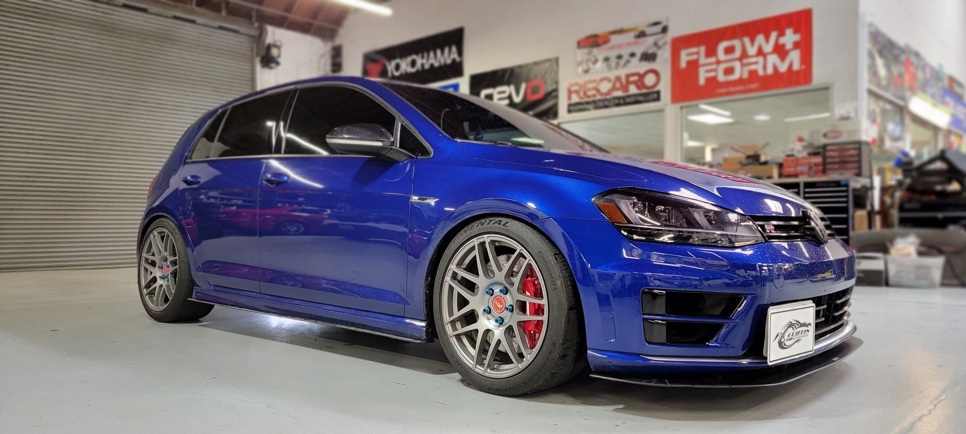 A blue volkswagen golf r is parked in a garage | Griffin Motorwerke