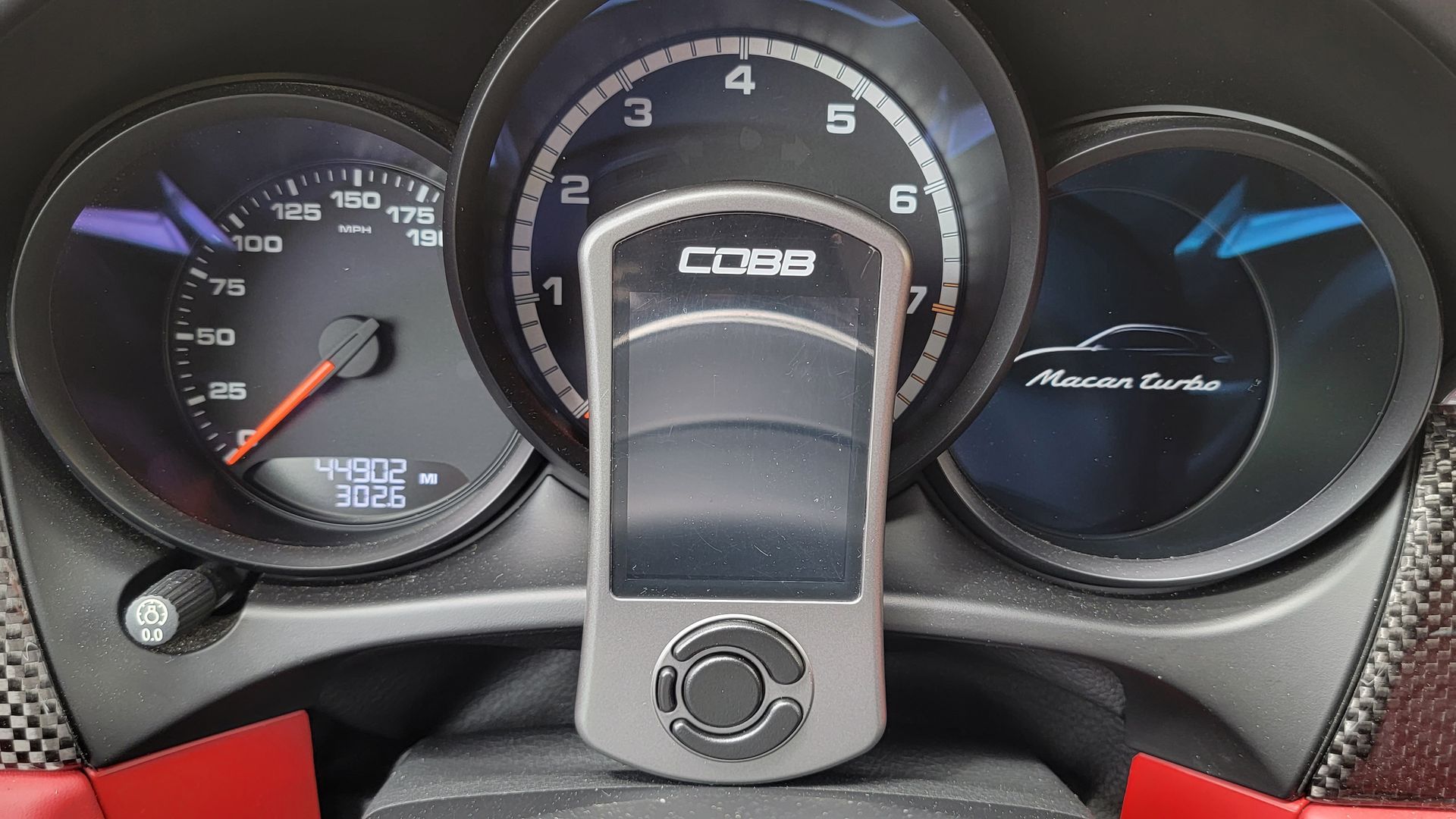 A close up of a car dashboard with a gps holder attached to it | Griffin Motorwerke