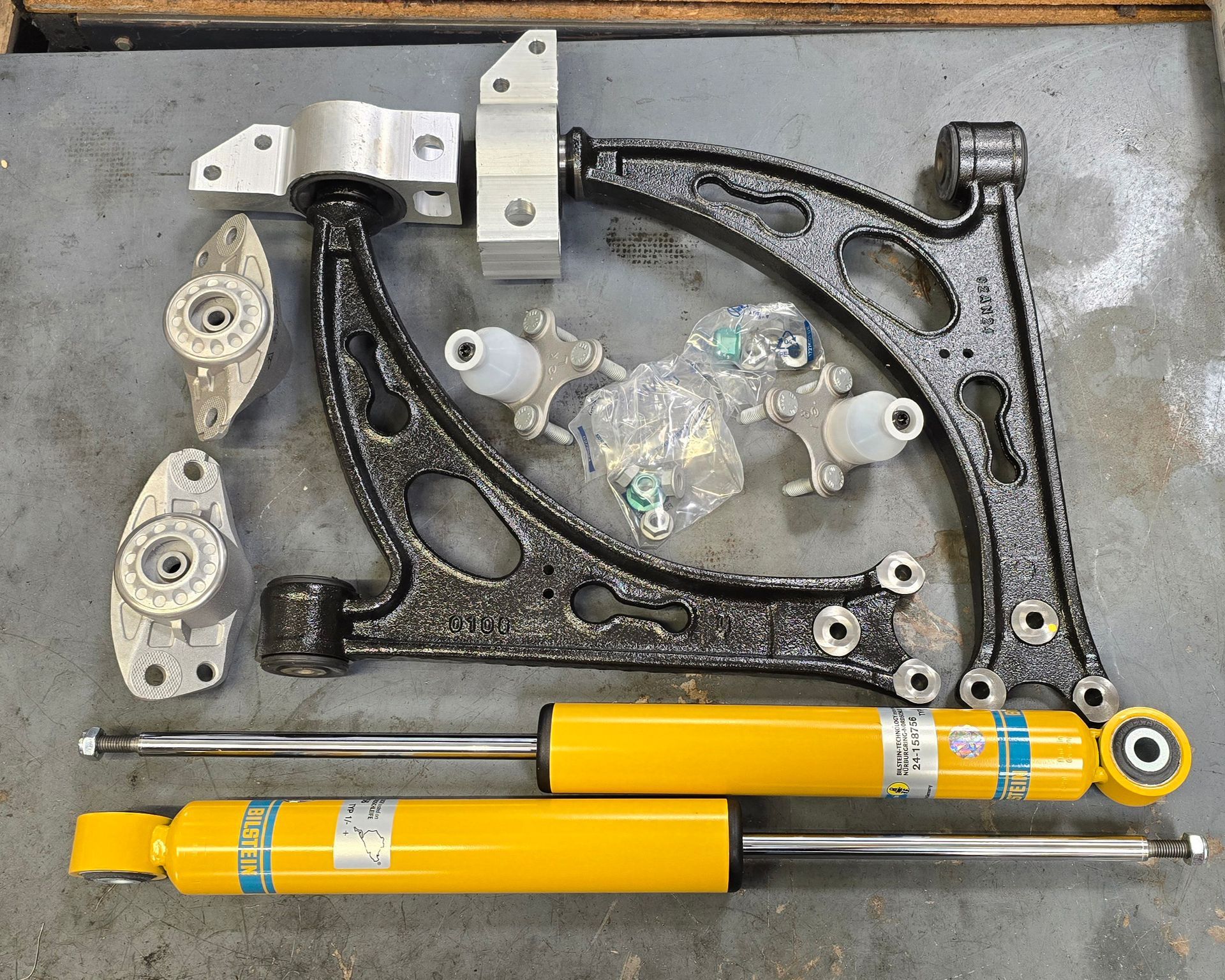 Suspension components including control arms, ball joints, and Bilstein B8 Sport shocks for VW Golf R.