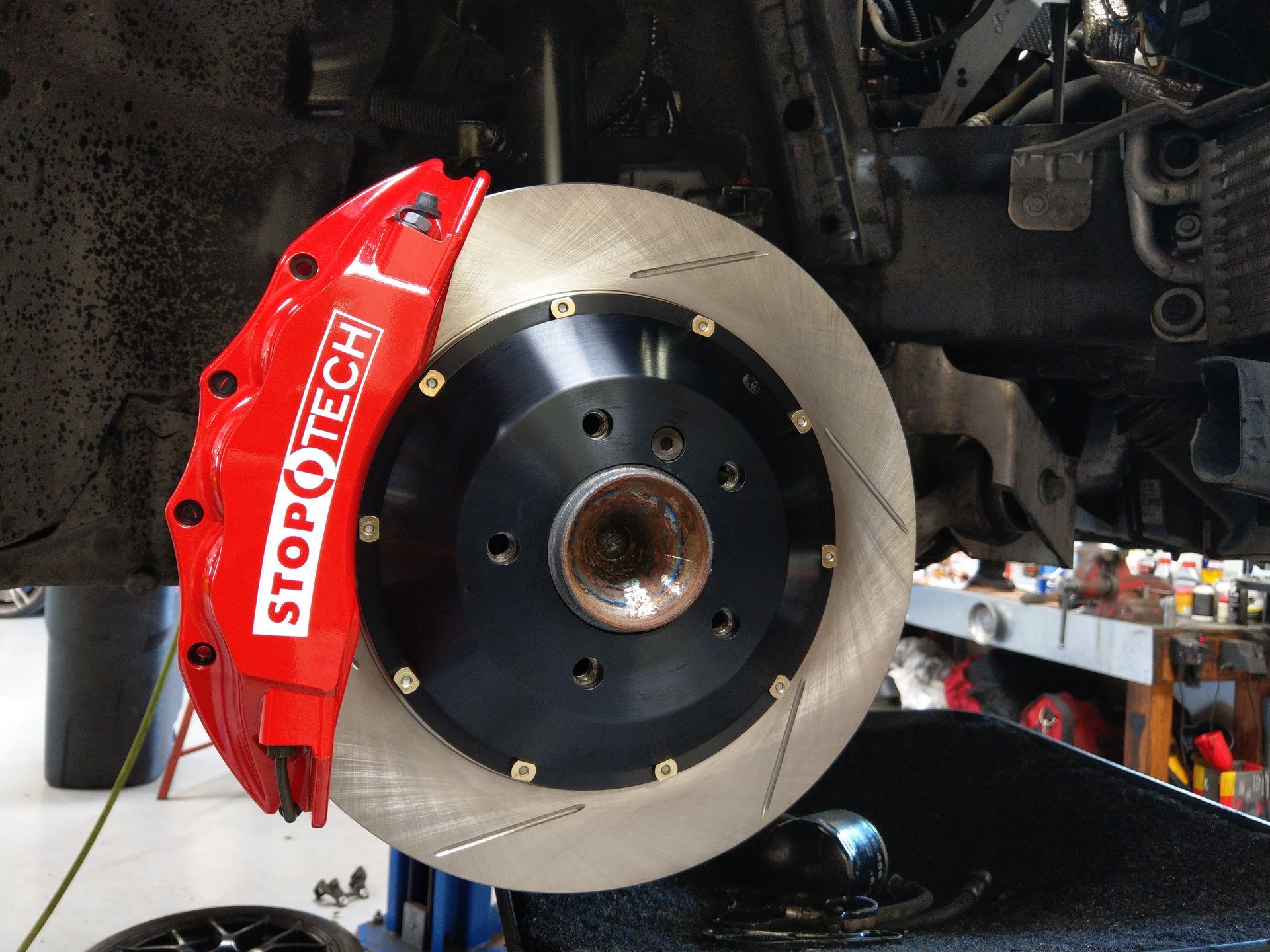 A red stop tech brake caliper is on a car | Griffin Motorwerke