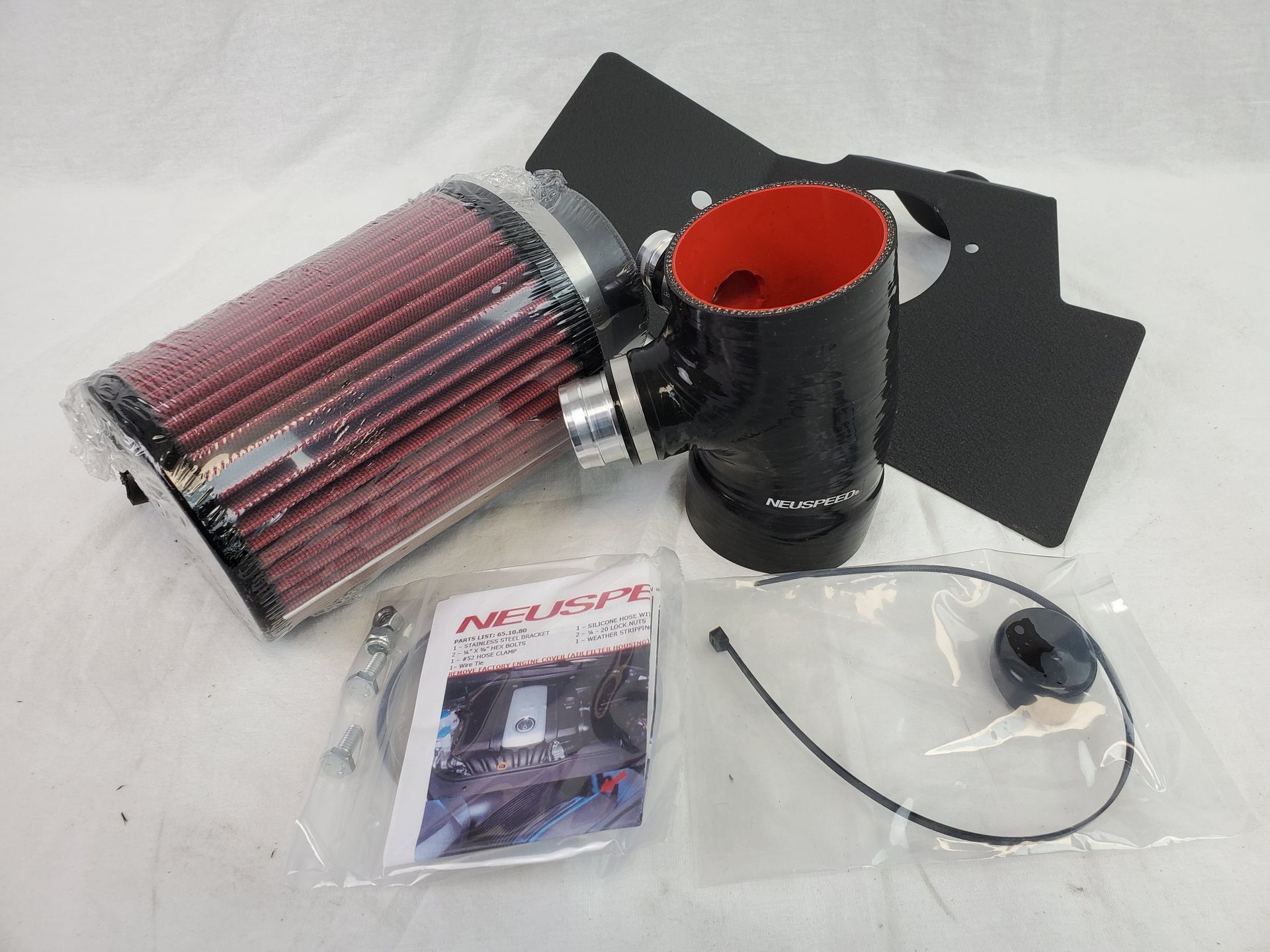 A k & n air filter is sitting next to a hose | Griffin Motorwerke