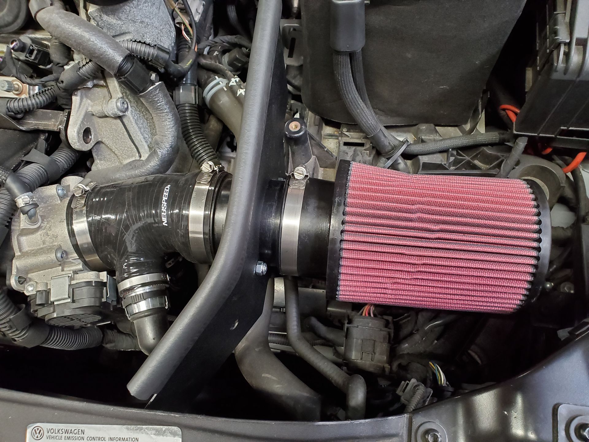 A close up of a car engine with a red filter | Griffin Motorwerke