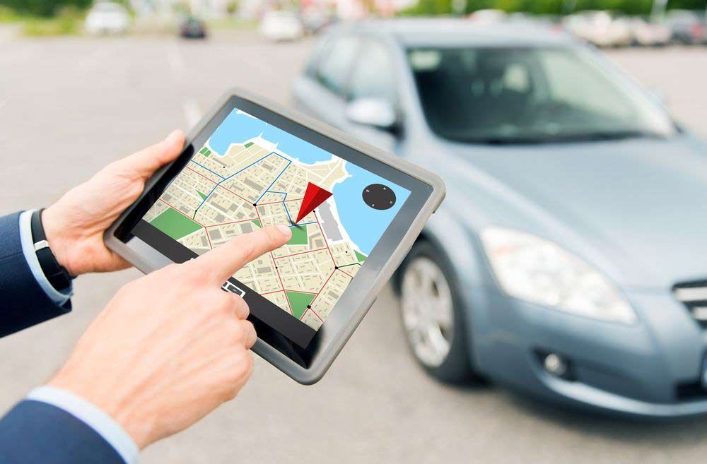 Close Up Image Of Hands With GPS On Tablet