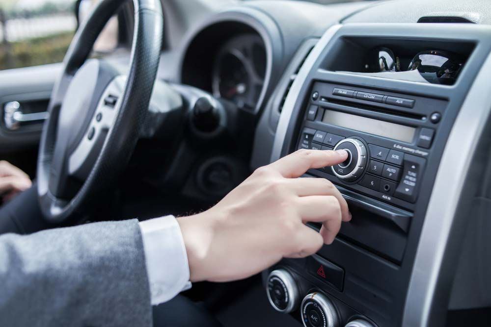 Man Using Car Audio Stereo System