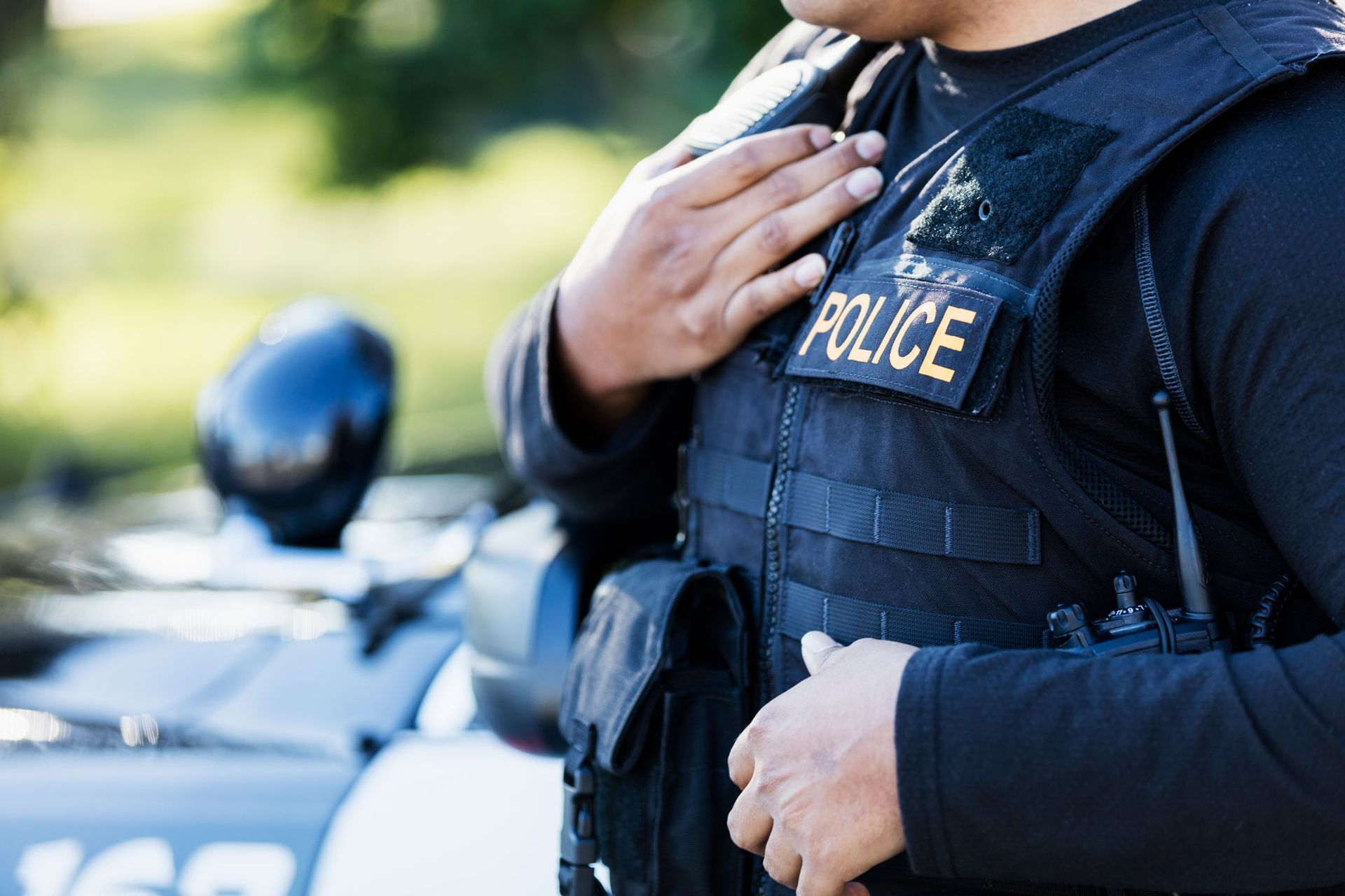 Police officer in black tactical vest with 