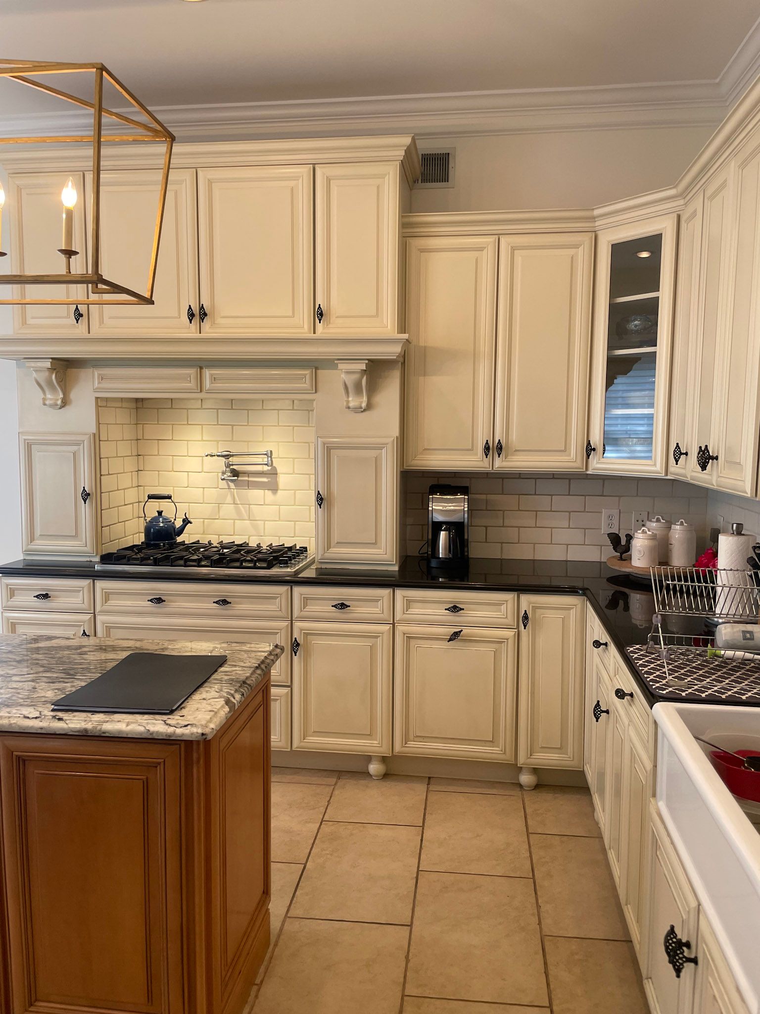 a kitchen with white cabinets and a large island