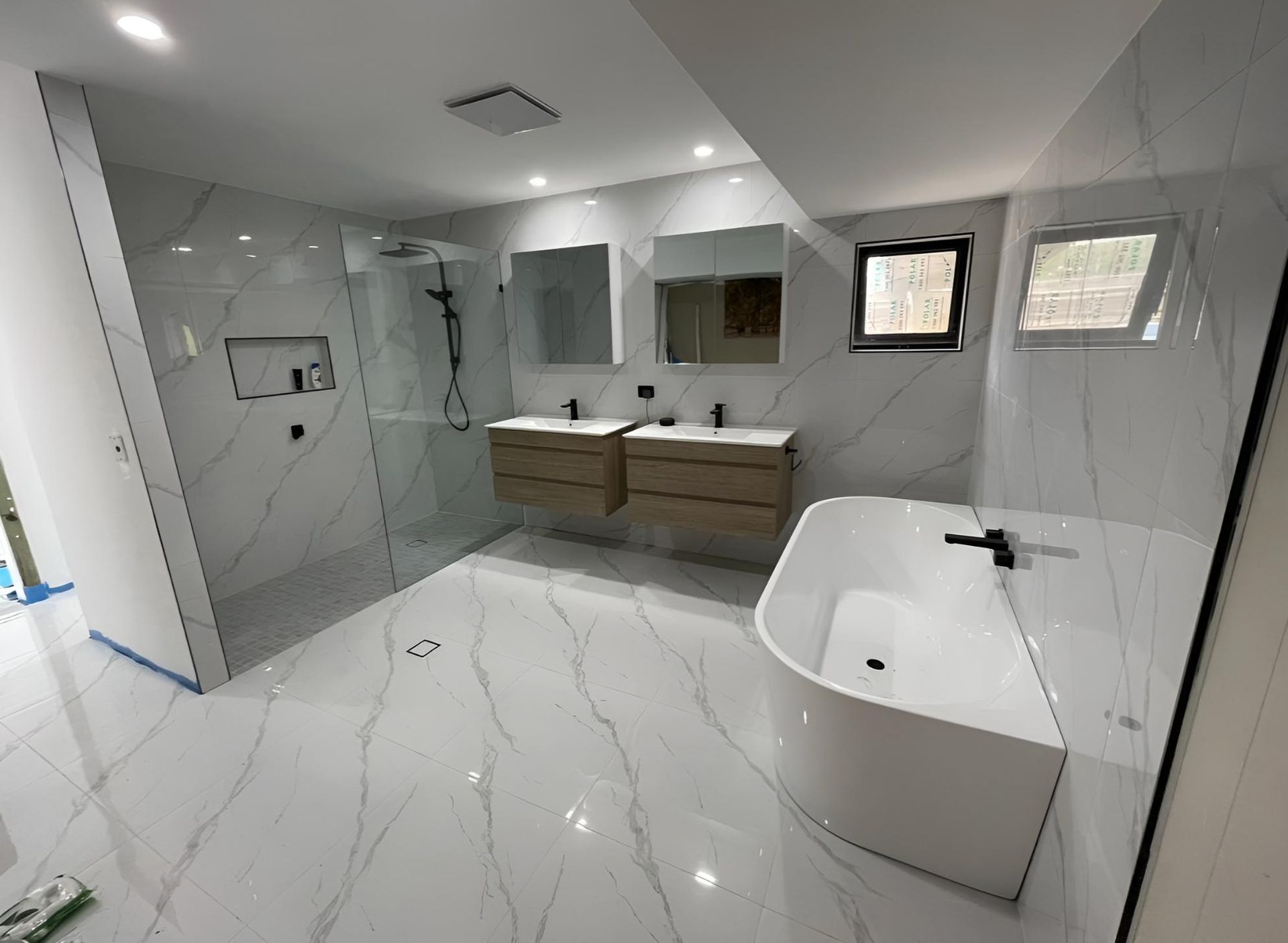 Bathroom With Two Sinks, a Bathtub and a Walk in Shower — Luke Barry Plumbing in Mudgeeraba, QLD