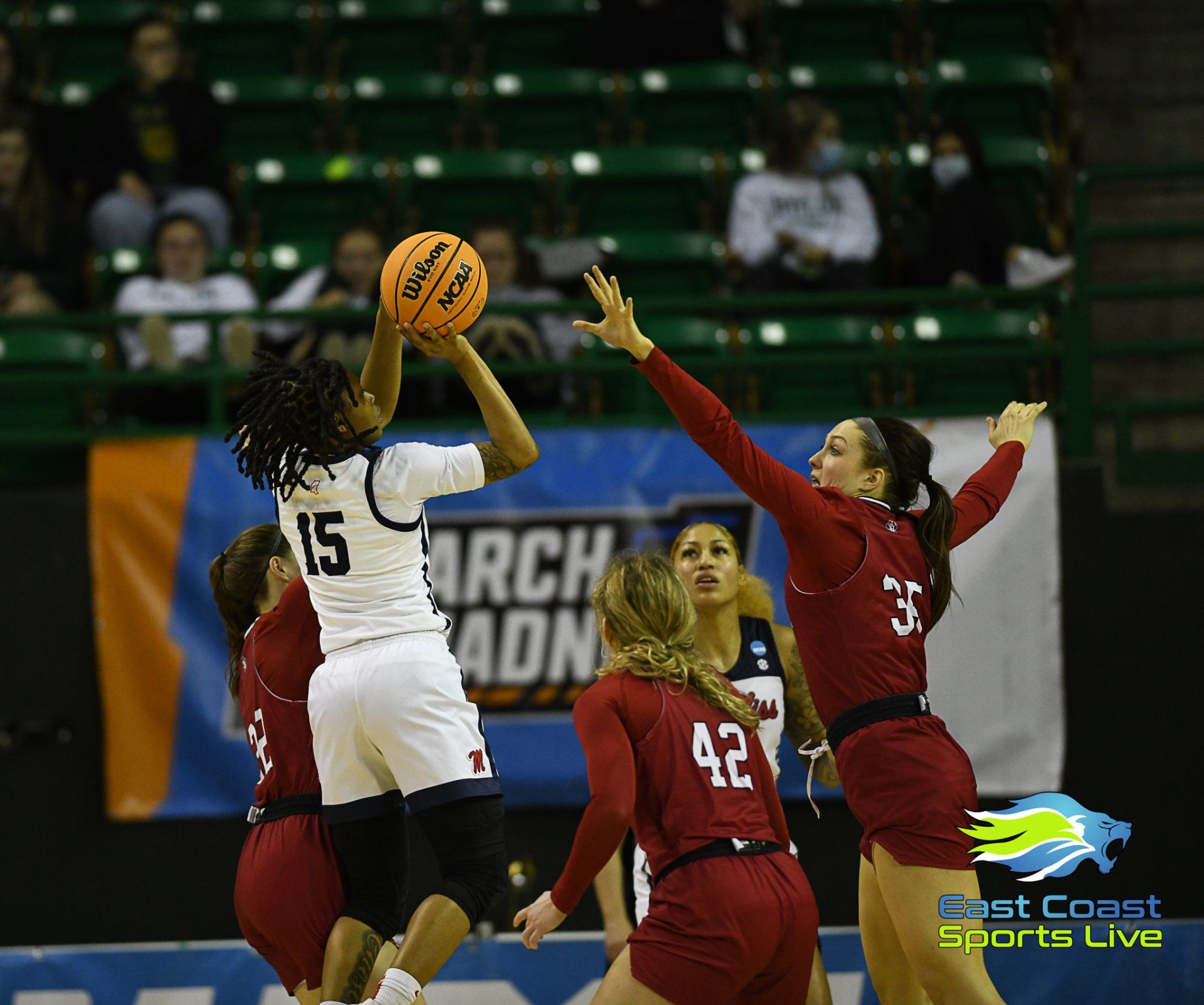 A female basketball player with the number 15 on her back