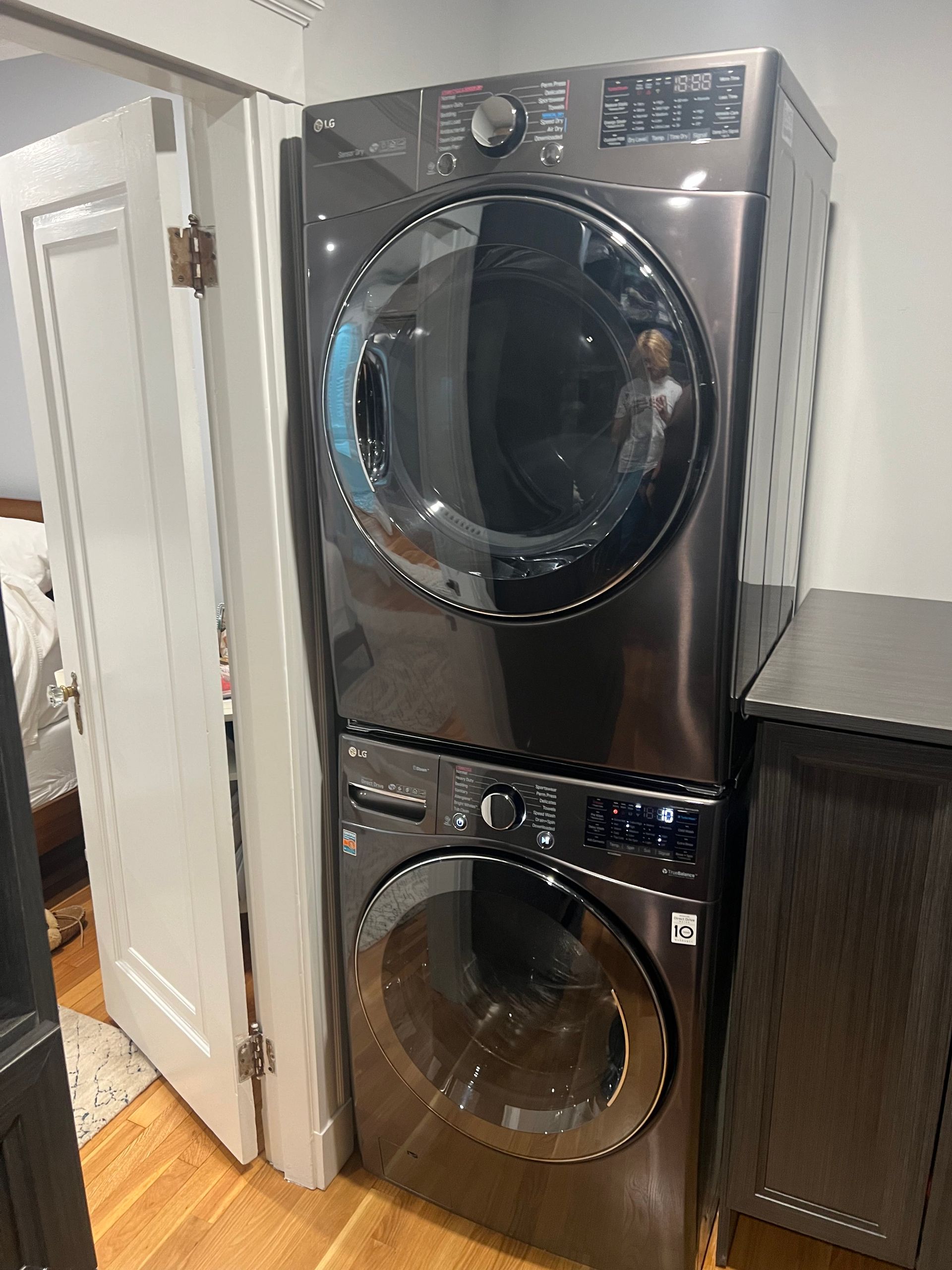 A washer and dryer are stacked on top of each other in a laundry room.