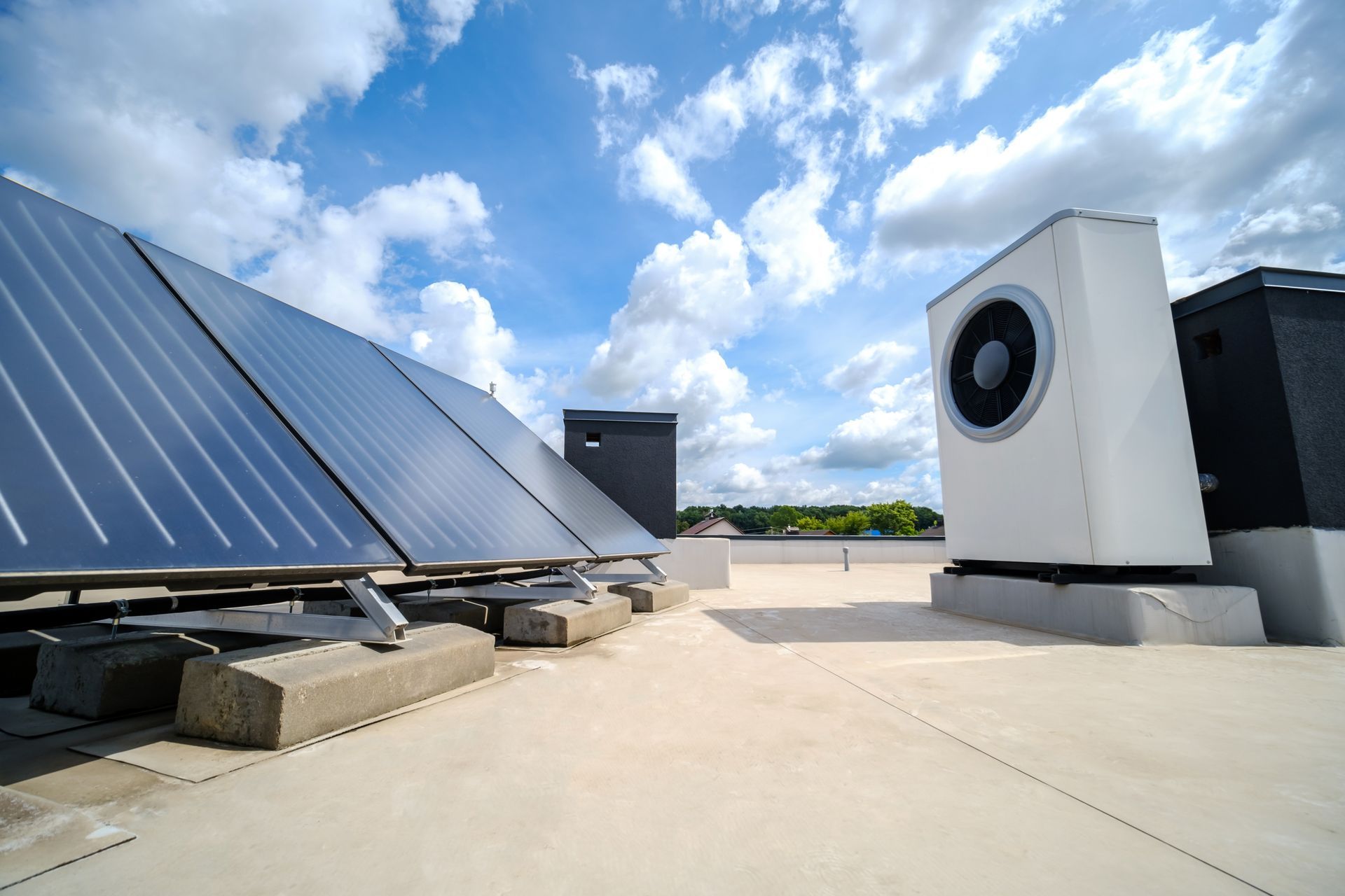 There are many solar panels on the roof of a building.