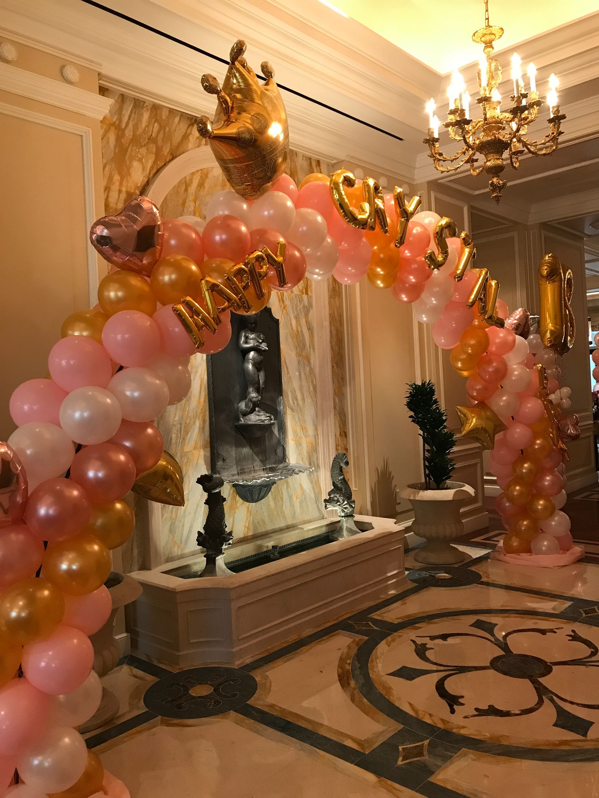 A pool table is decorated with balloons for a birthday