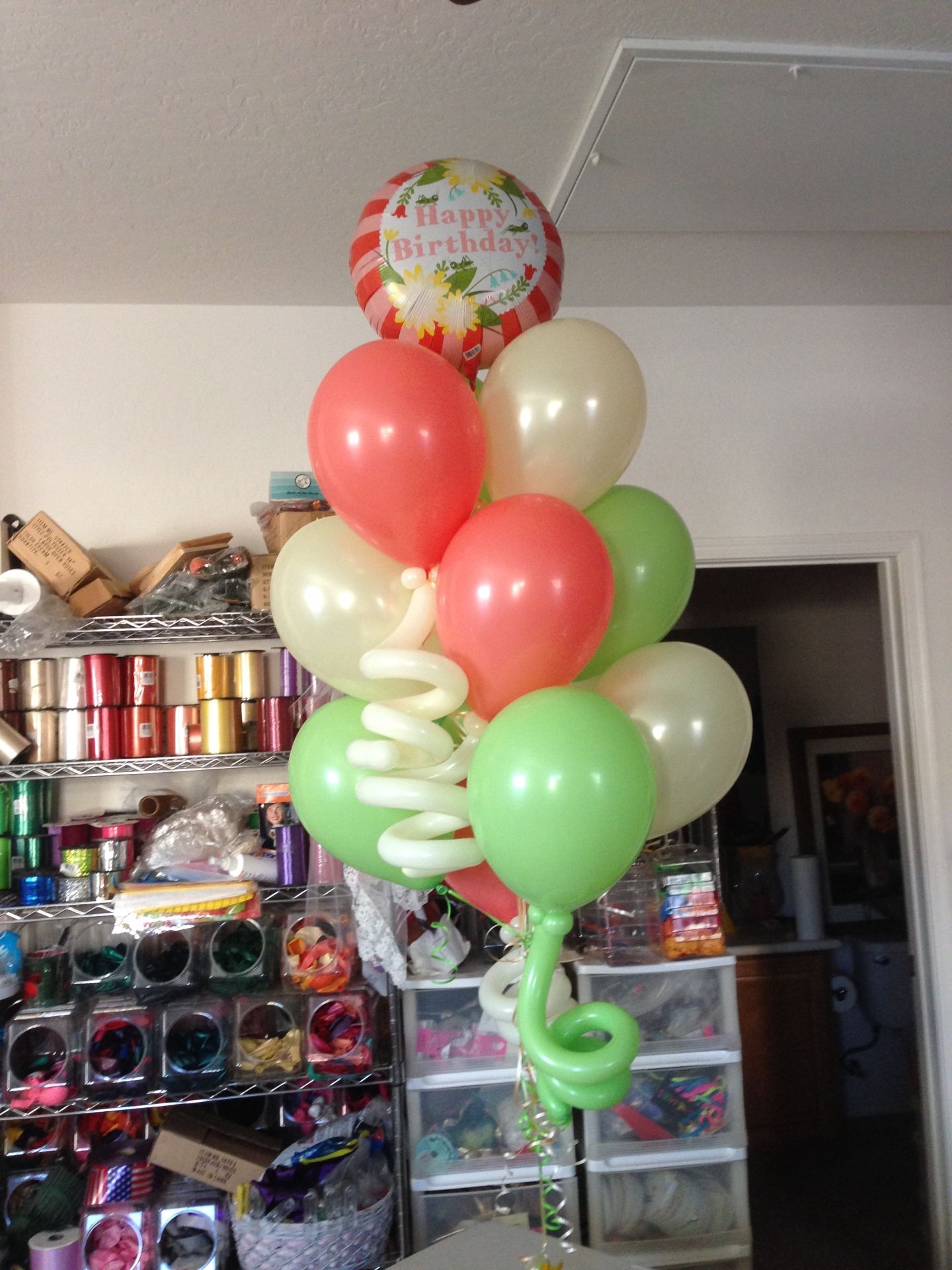 A bunch of balloons with one that says happy birthday