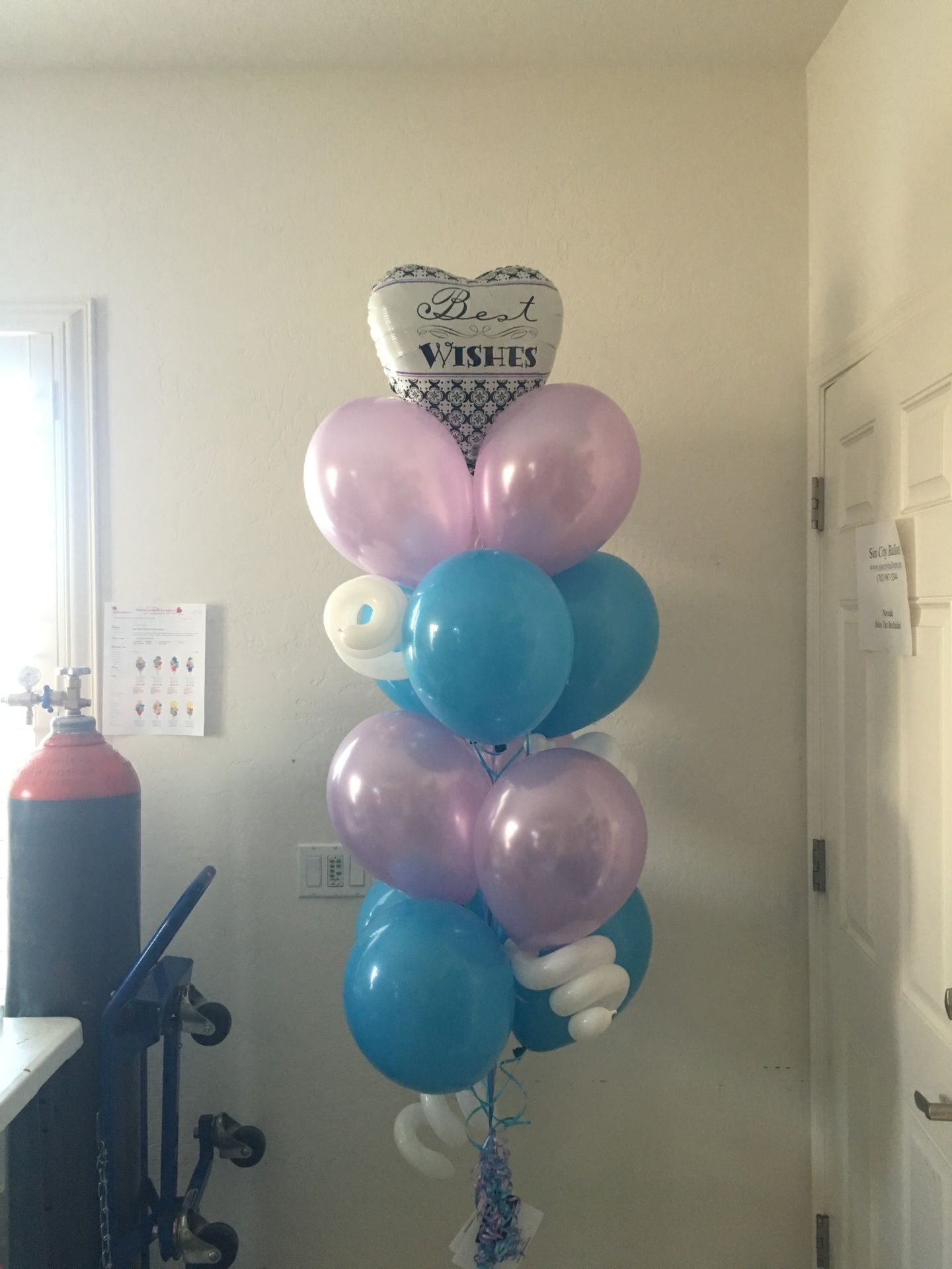 A bunch of balloons are stacked on top of each other in a room.