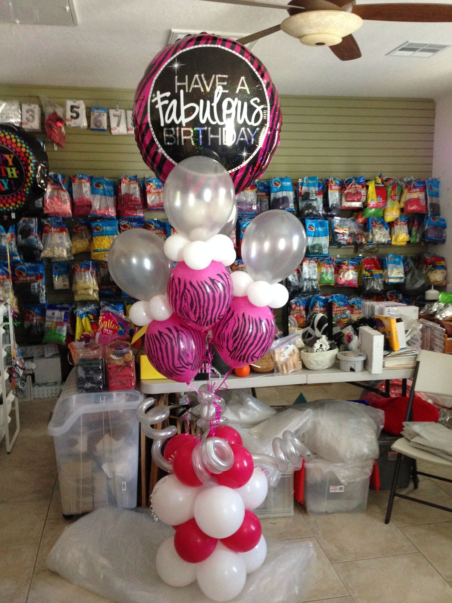 A bunch of balloons with one that says have a fabulous birthday