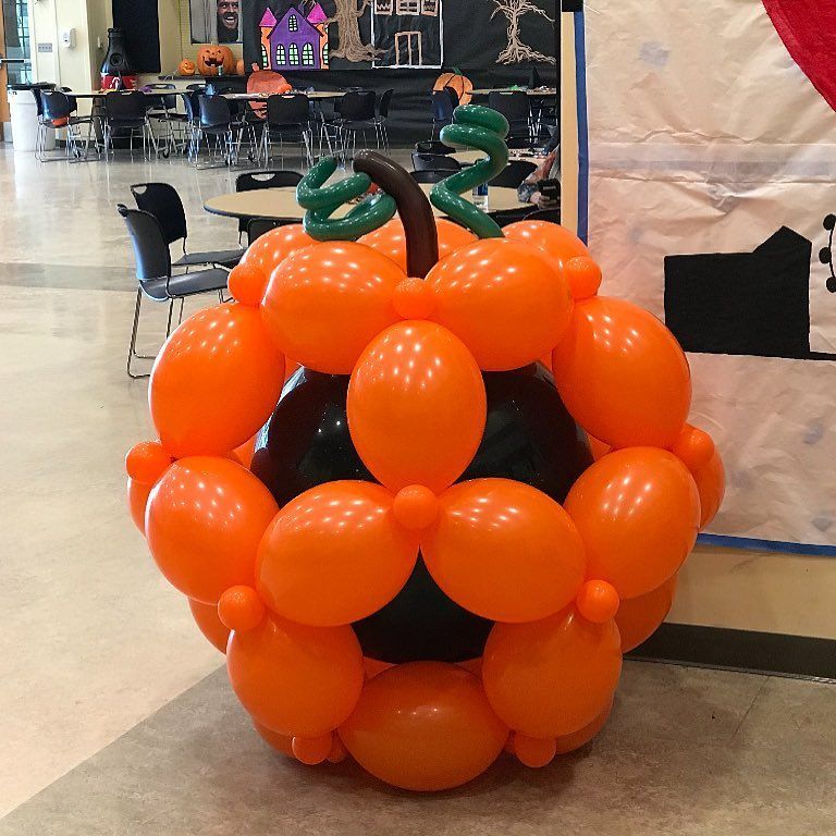 A large pumpkin made out of orange balloons
