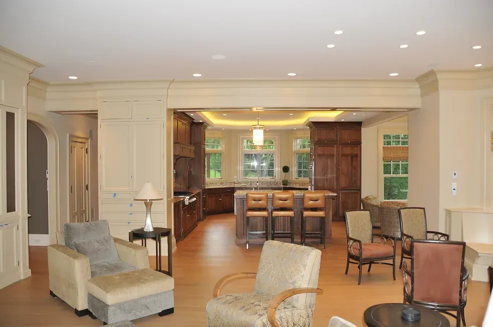 luxury wainscoting, paneling, molding and cabinets for an open concept living room and kitchen