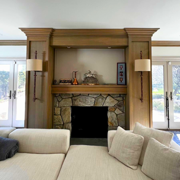 bold walnut fireplace mantle with lighting