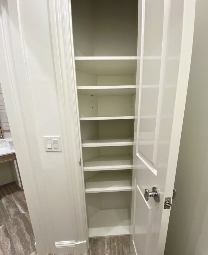 storage closet added to small extra space in bathroom