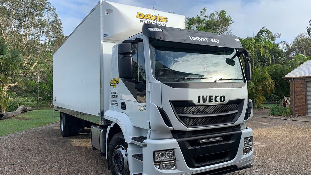 A White Iveco Truck is Parked in a Gravel Lot — Davis Removals & Storage in Dundowran, QLD