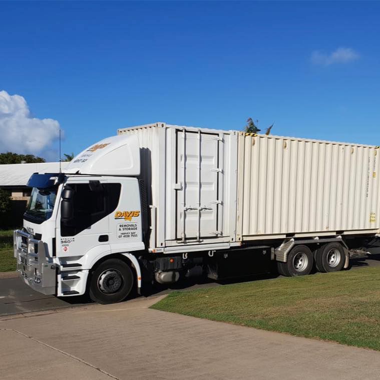 A White Truck With a Container on the Back is Parked on the Side of the Road — Davis Removals & Storage in Noosa Heads, QLD