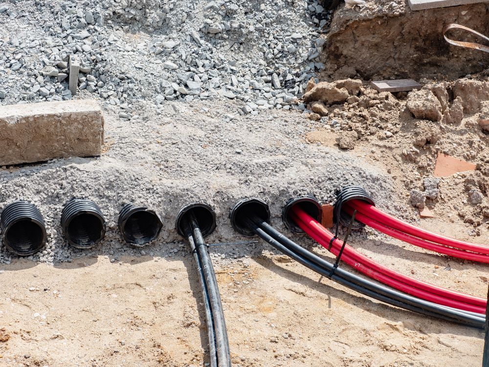 Electrical Cables in Conduits Laid in a Trench, Ready for Covering — Gold City Solar & Electrical in Tin Can Bay, QLD
