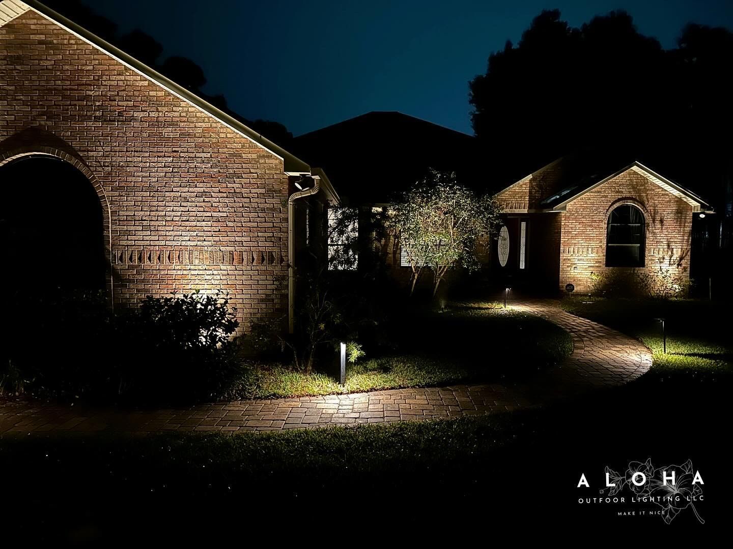 Night exterior of buildings with pathway lighting.
