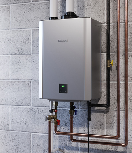 Wall-mounted gray water heater with copper pipes in a utility room
